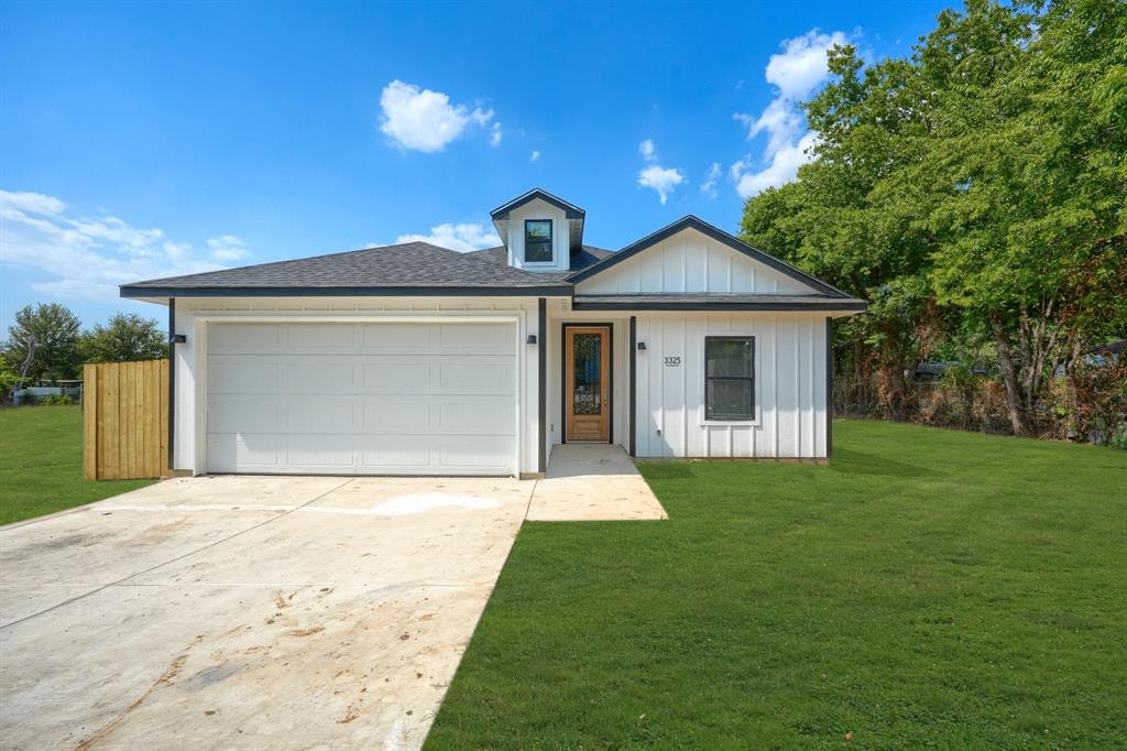 a front view of house with yard and green space