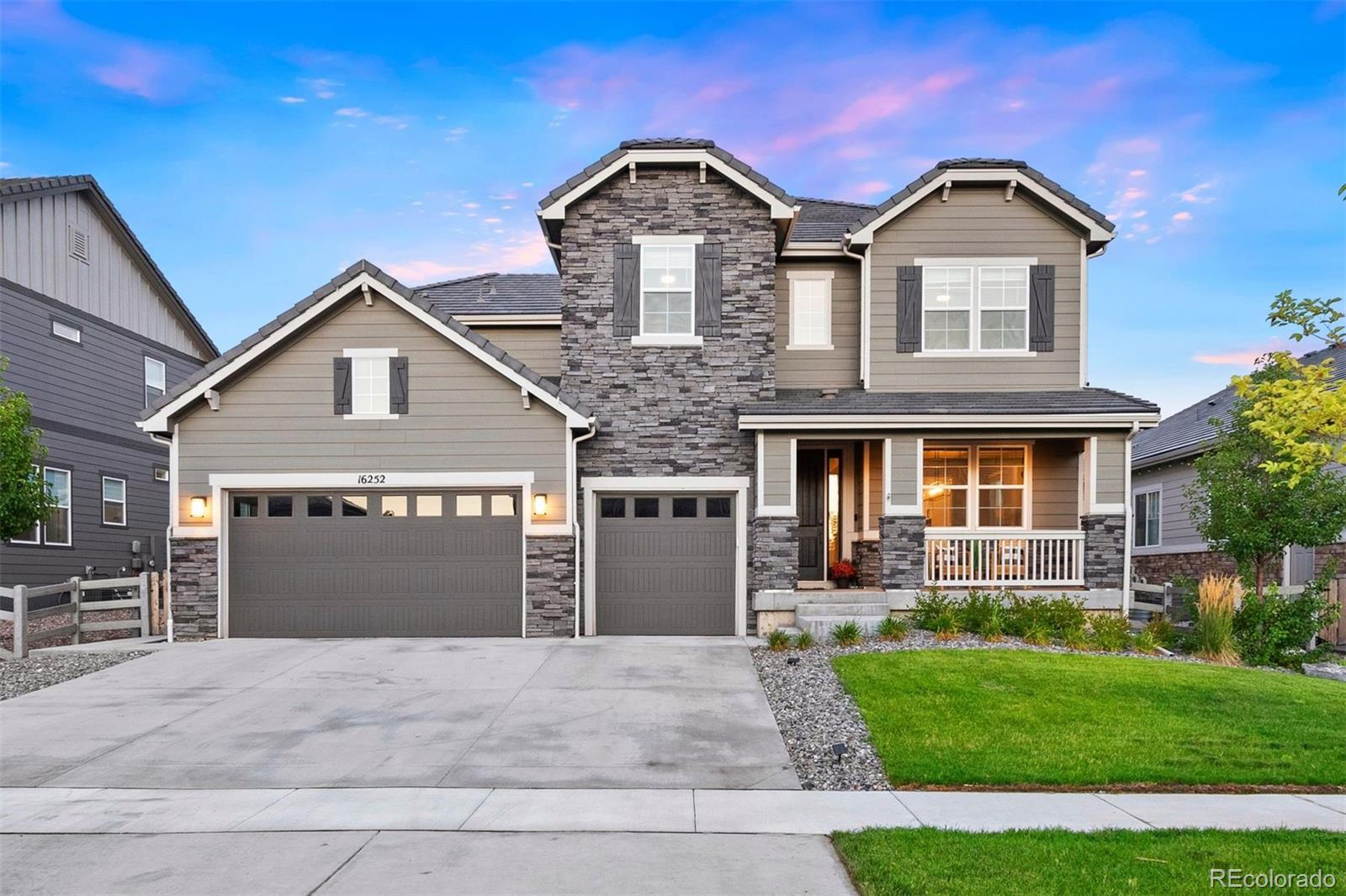 a front view of a house with a yard and garage