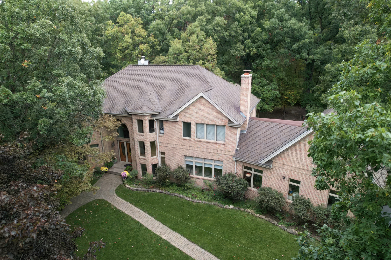 a aerial view of a house next to a yard