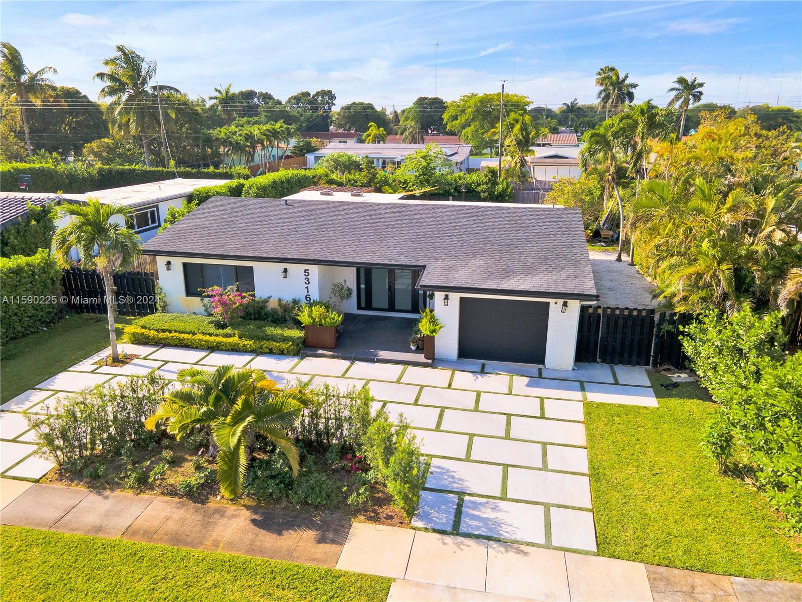 a front view of house with yard outdoor seating and green space