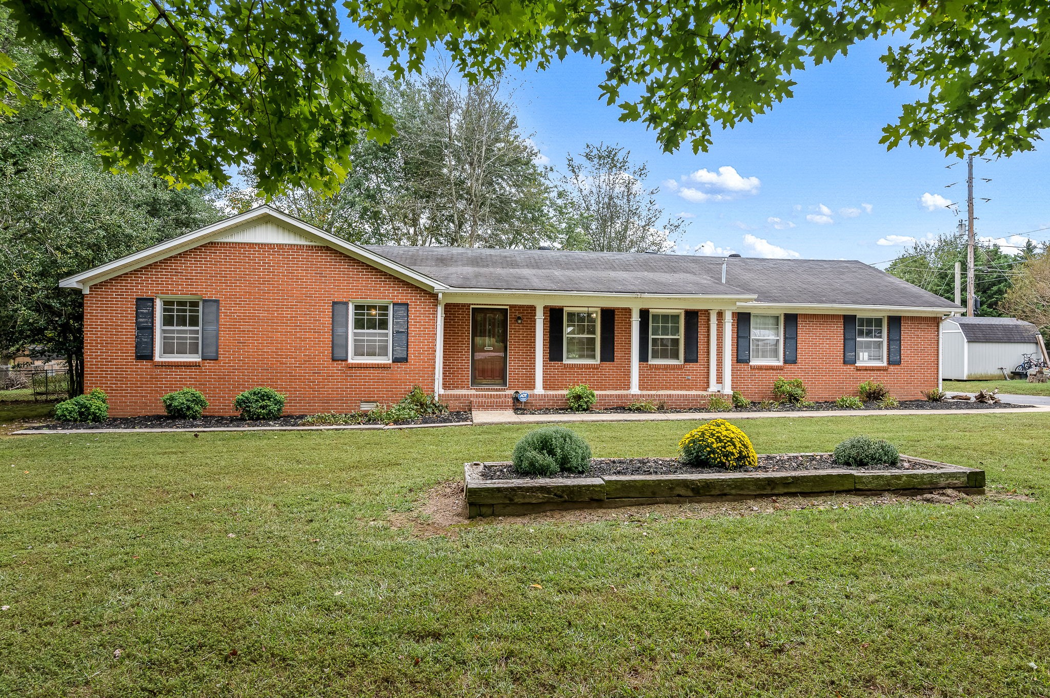 a front view of a house with a garden