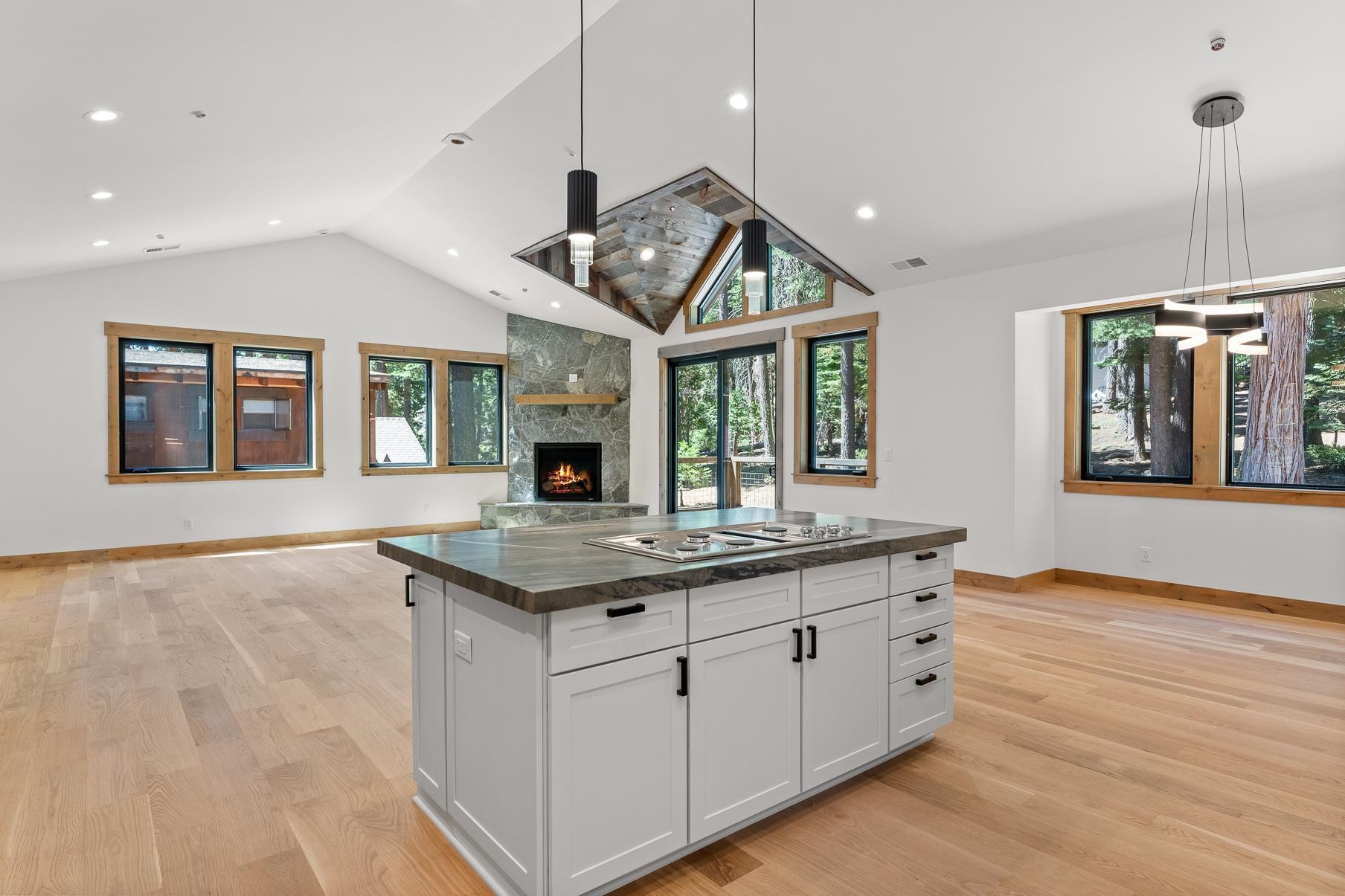 a kitchen with granite countertop a stove and a wooden floors