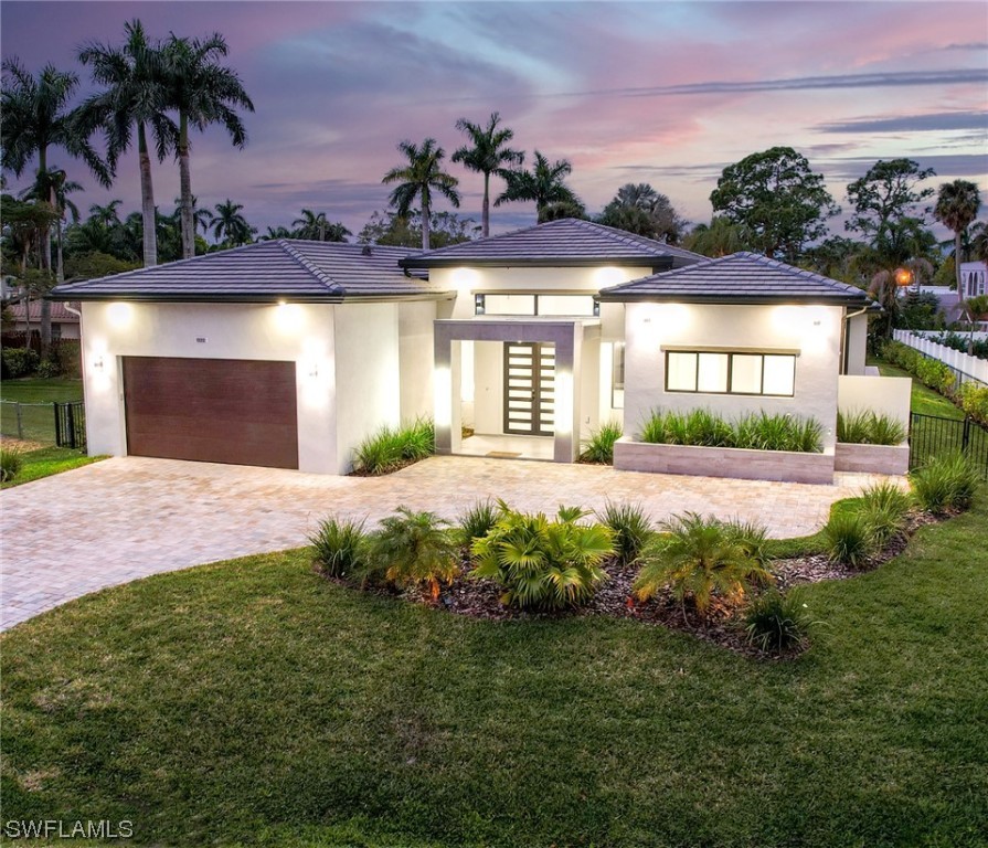 a front view of a house with garden