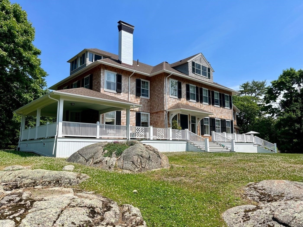 a front view of a house with a garden and plants