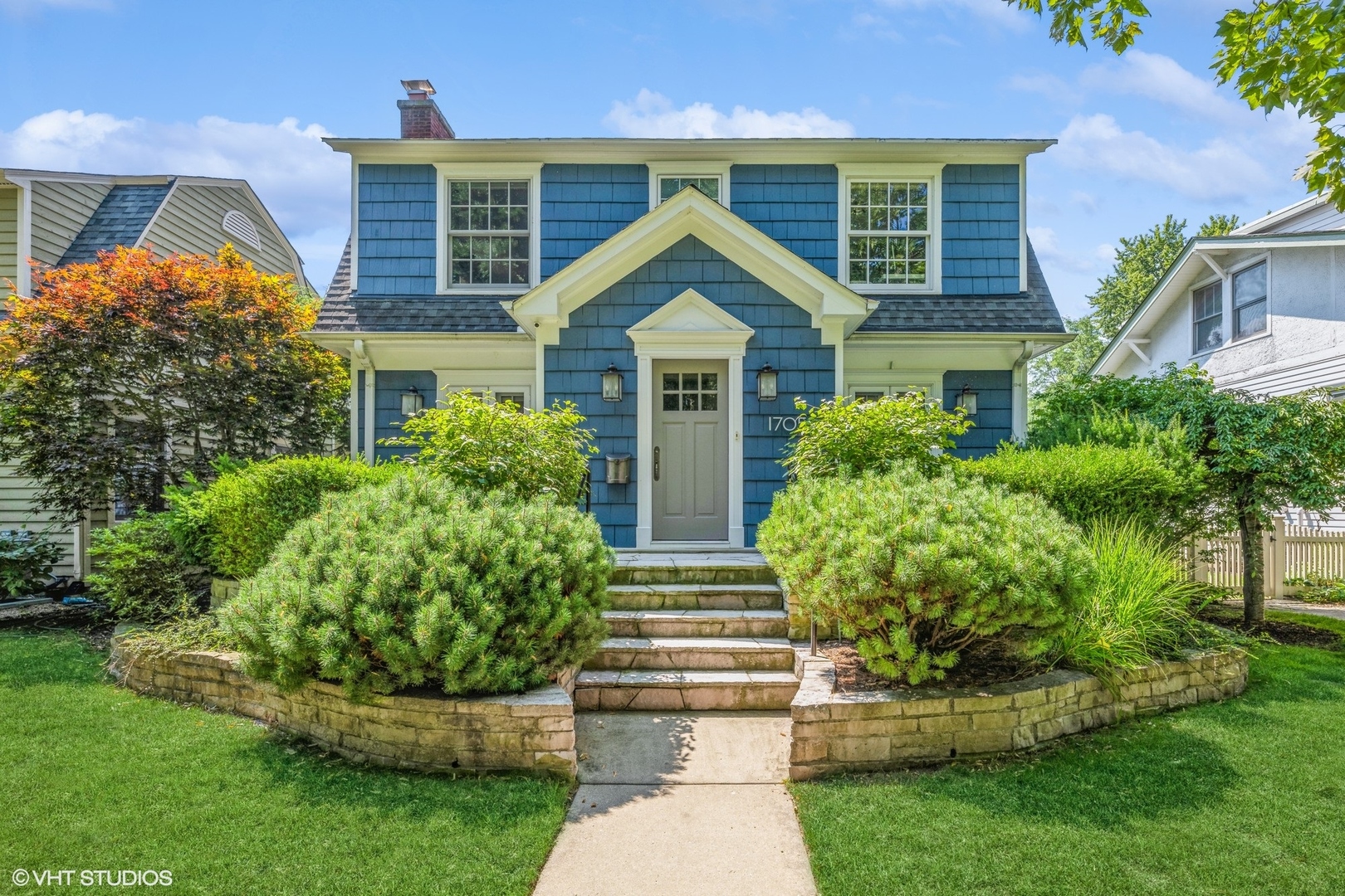 a front view of house with yard and green space