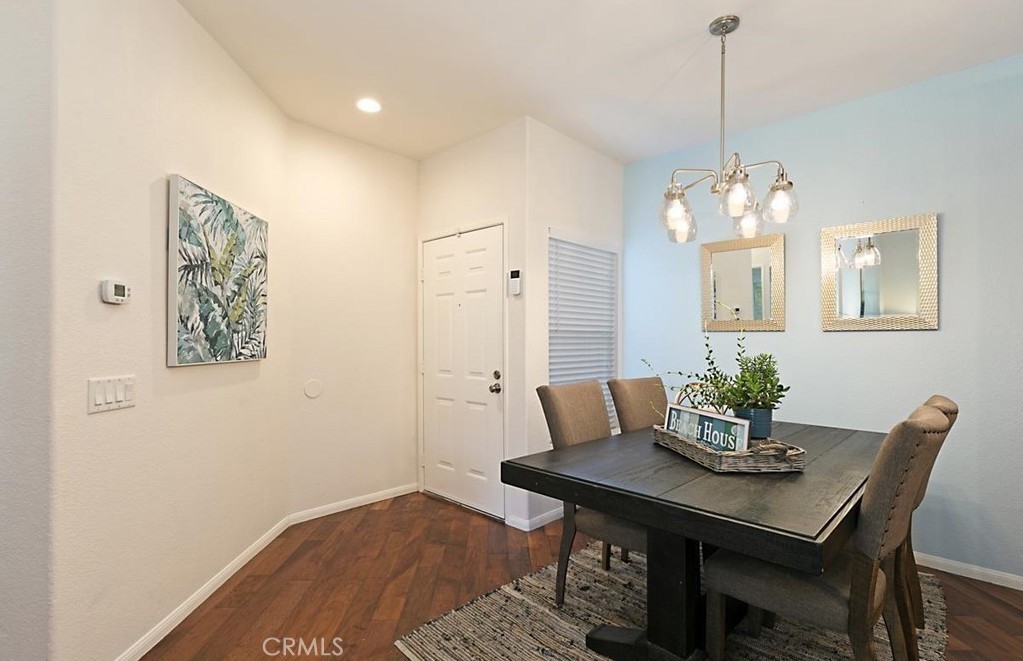 a view of a dining room with furniture and chandelier