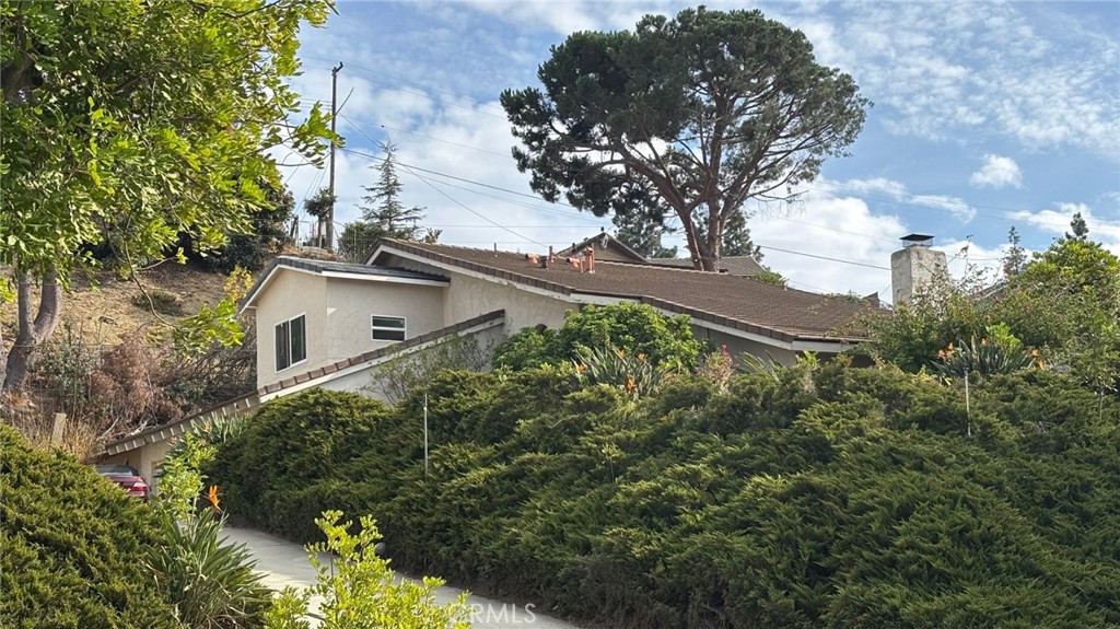 a view of a house with a yard and fountain