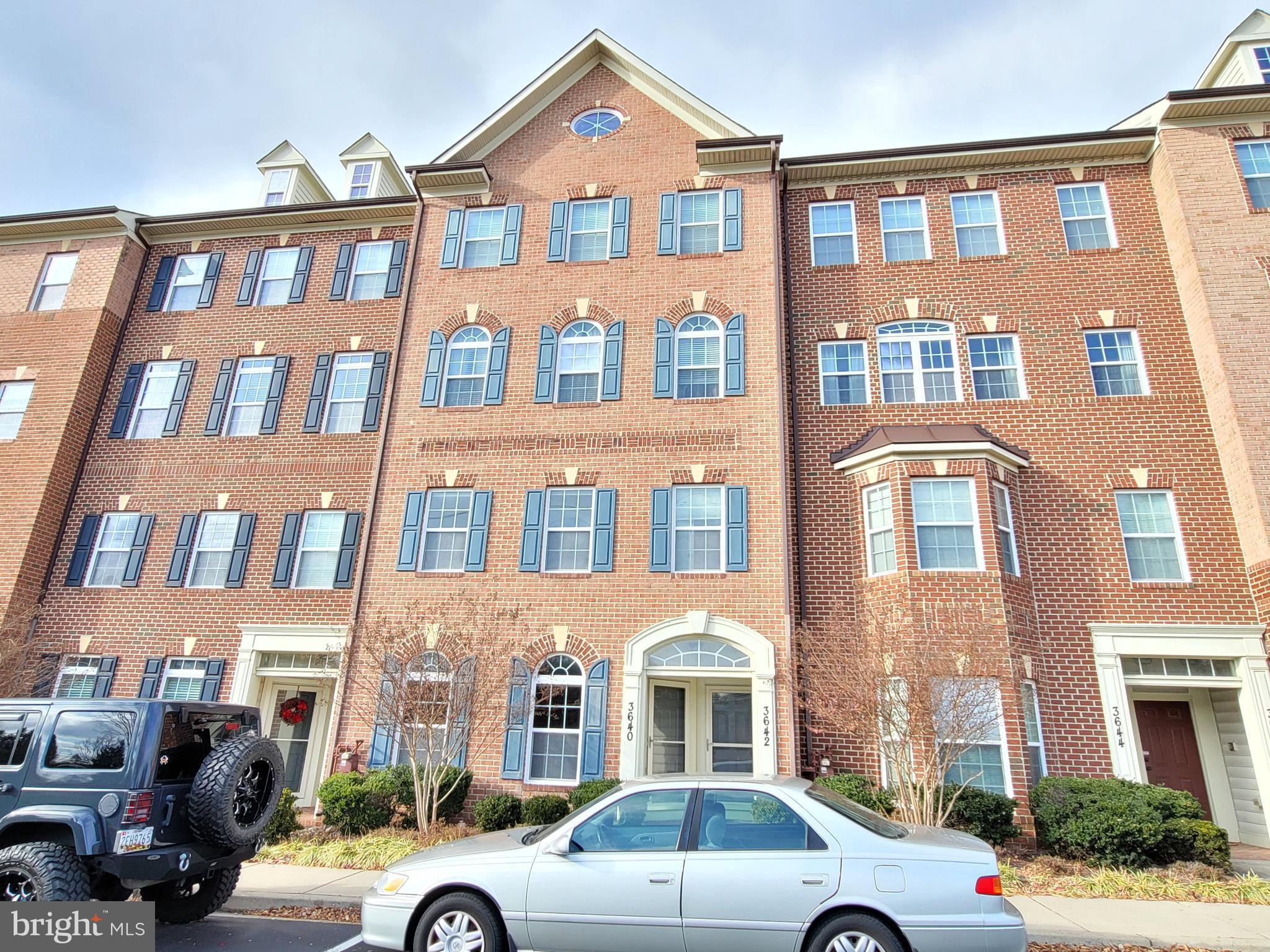 a front view of a residential apartment building with a yard