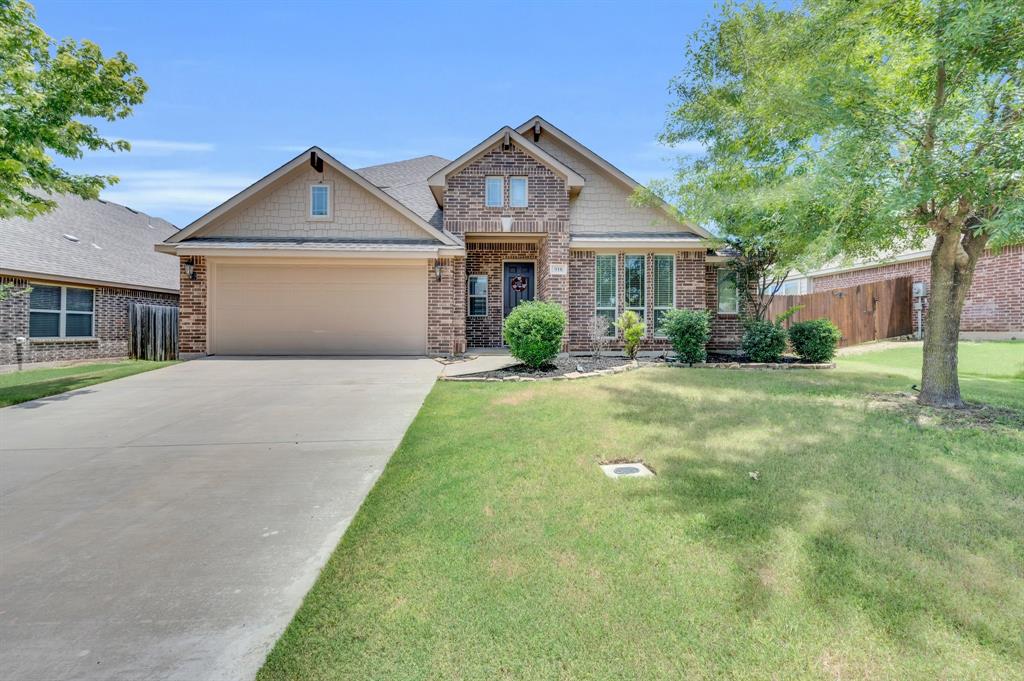 a front view of a house with yard and green space