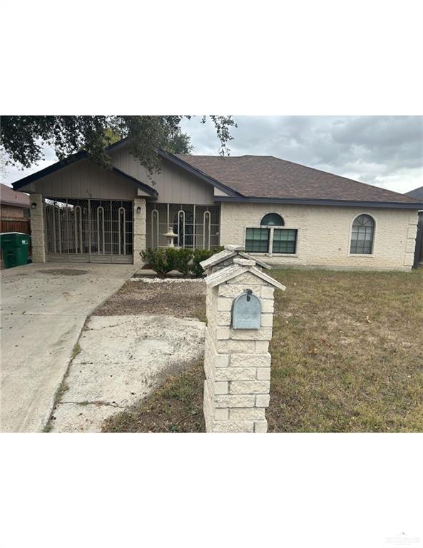 View of front of home with a front lawn and a carport