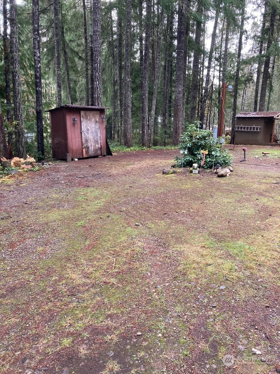 a front view of a house with a yard and tree