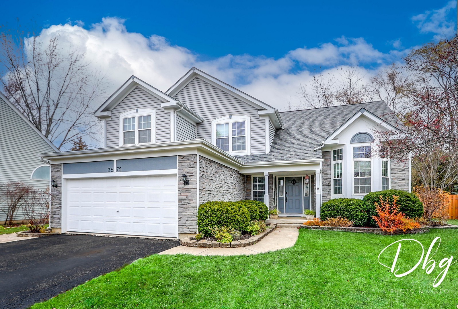 a front view of a house with a yard and garage