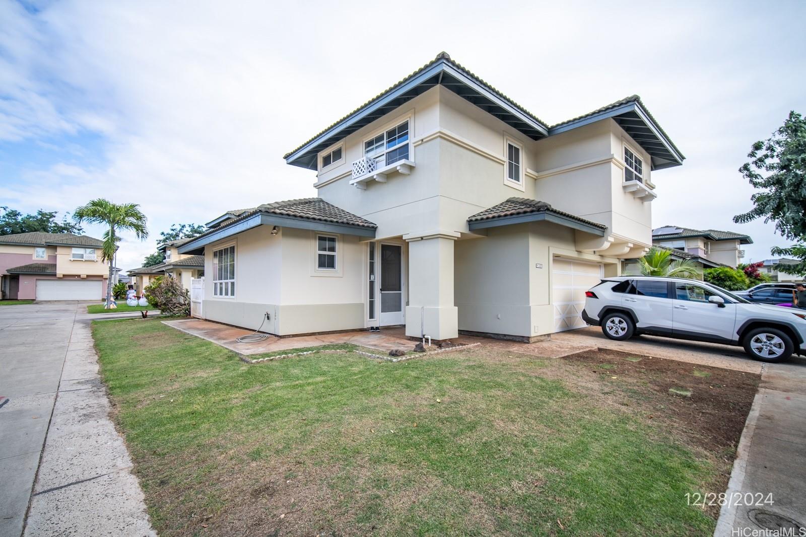 a view of a house with a yard and garage