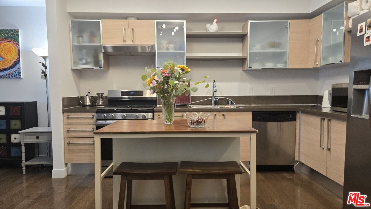 a kitchen with stainless steel appliances a sink and cabinets