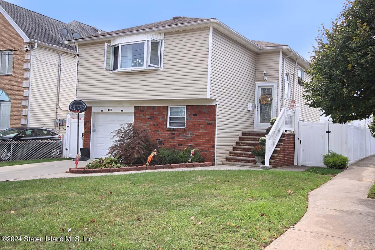 a front view of brick house with a yard