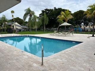 a view of a swimming pool and lounge chairs