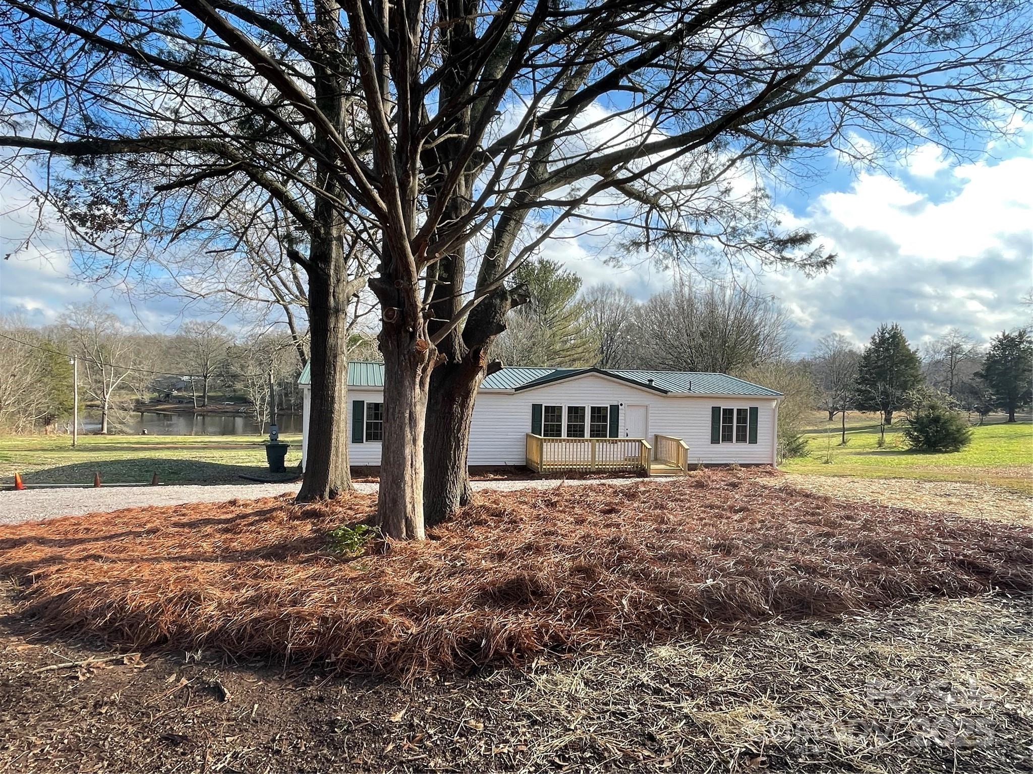 a view of house with backyard and tree