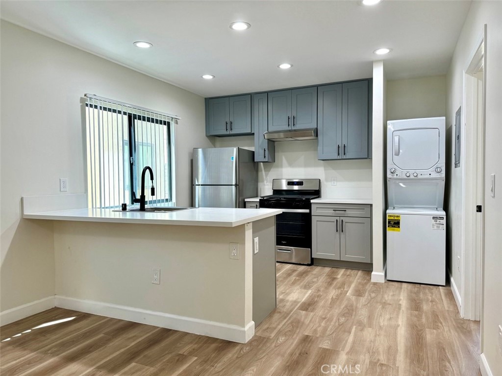 a kitchen with refrigerator and cabinets