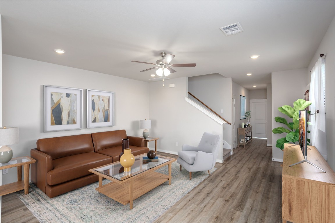 a living room with furniture and wooden floor