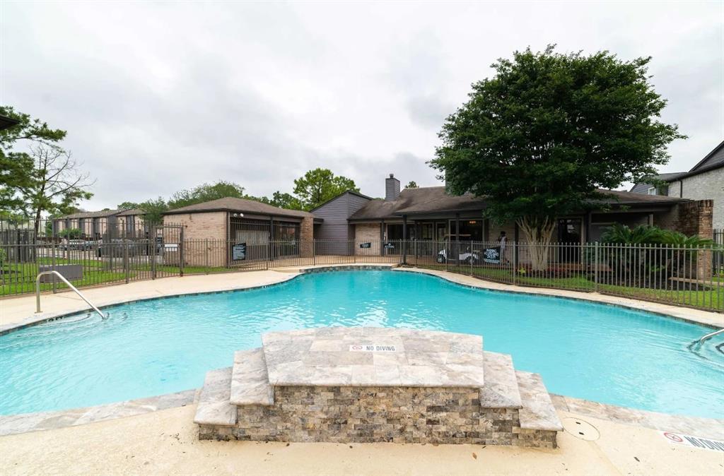 a front view of a house with swimming pool having outdoor seating