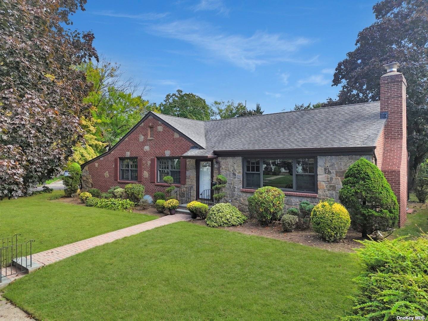 a front view of a house with garden