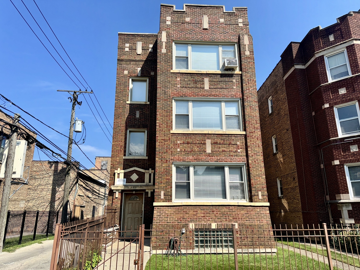 a front view of a residential apartment building with a yard