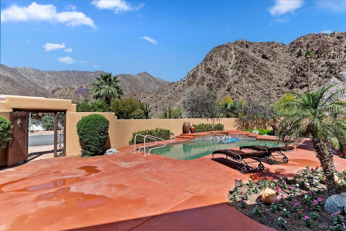 a view of backyard with swimming pool and outdoor seating