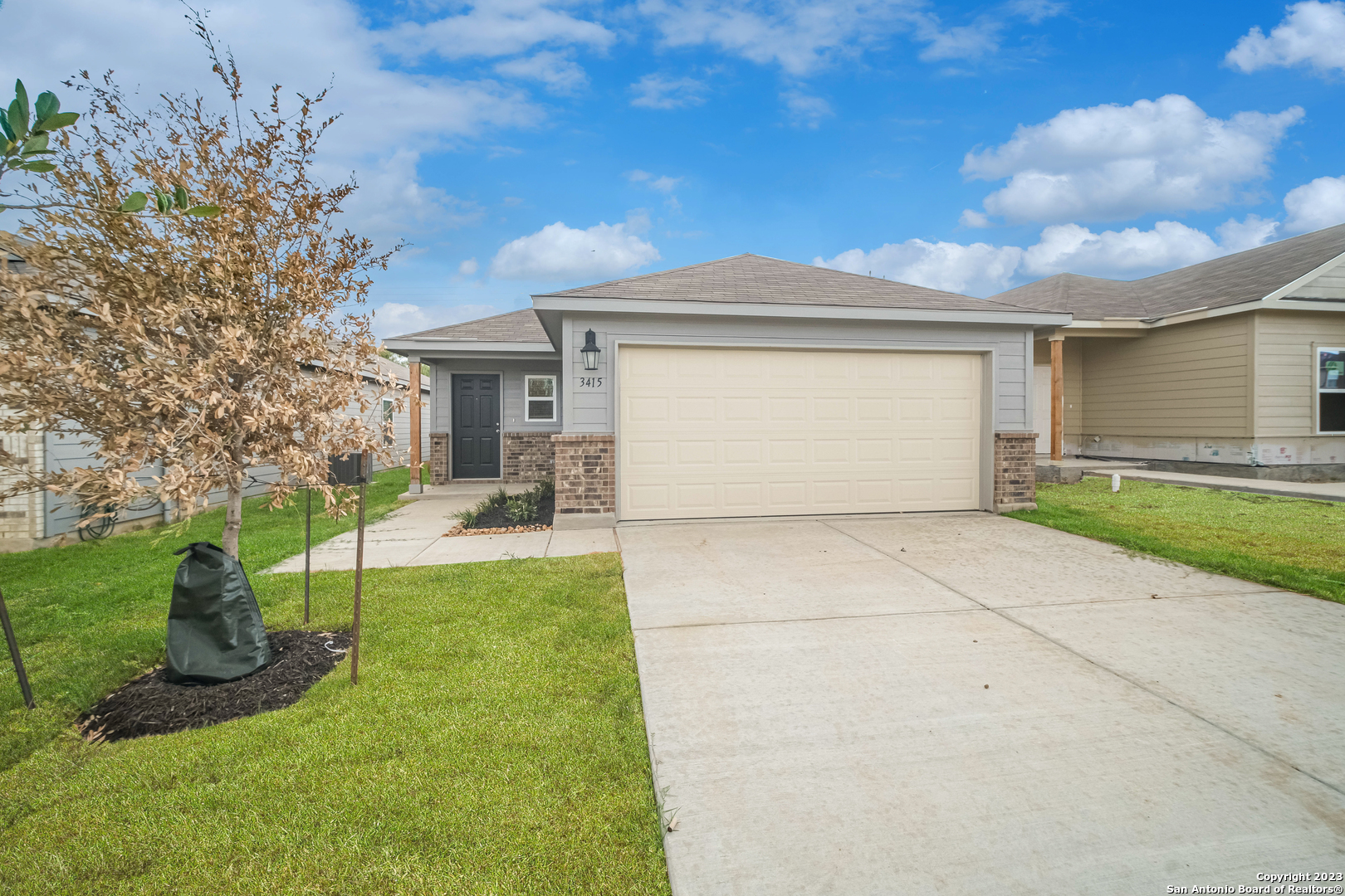 a front view of a house with a yard and garage