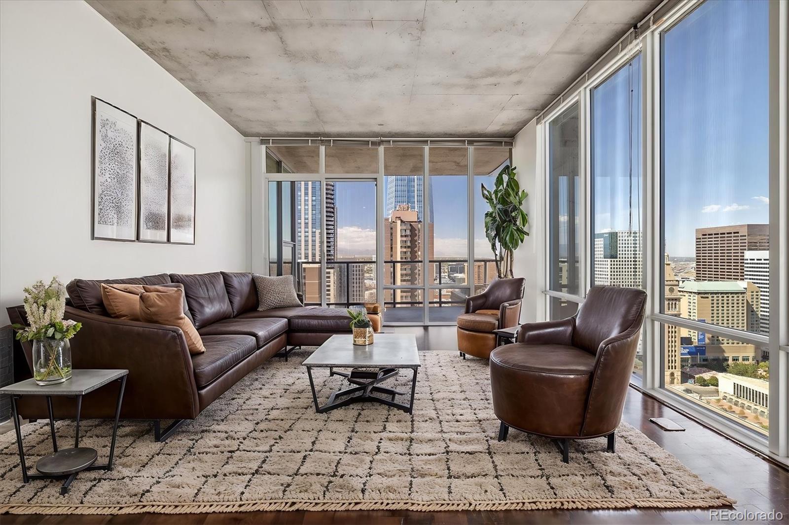 a living room with furniture and a potted plant