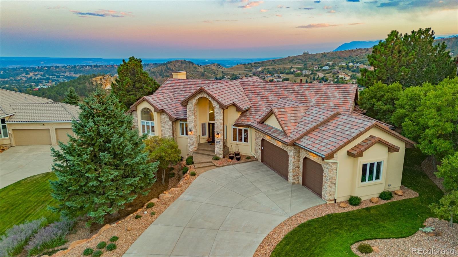 an aerial view of a house with a yard and balcony