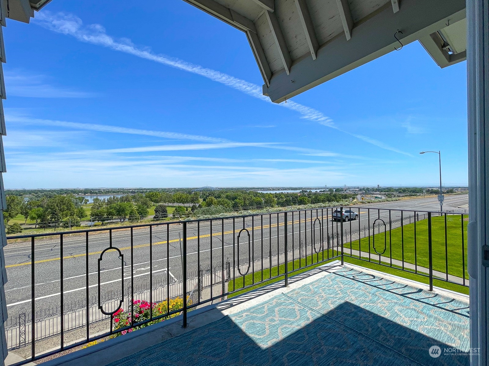 a view of a balcony with wooden floor