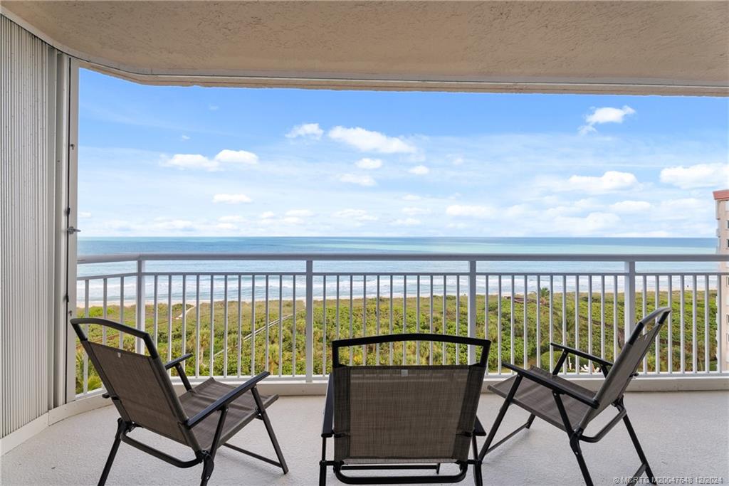 a view of a chair and table in the balcony