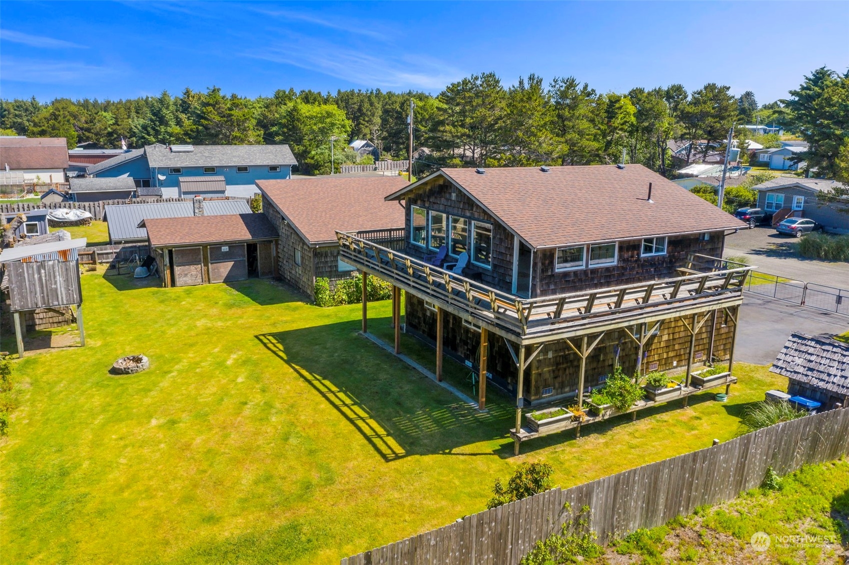 a aerial view of a house with swimming pool and large trees