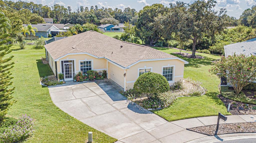 a aerial view of a house with yard and furniture