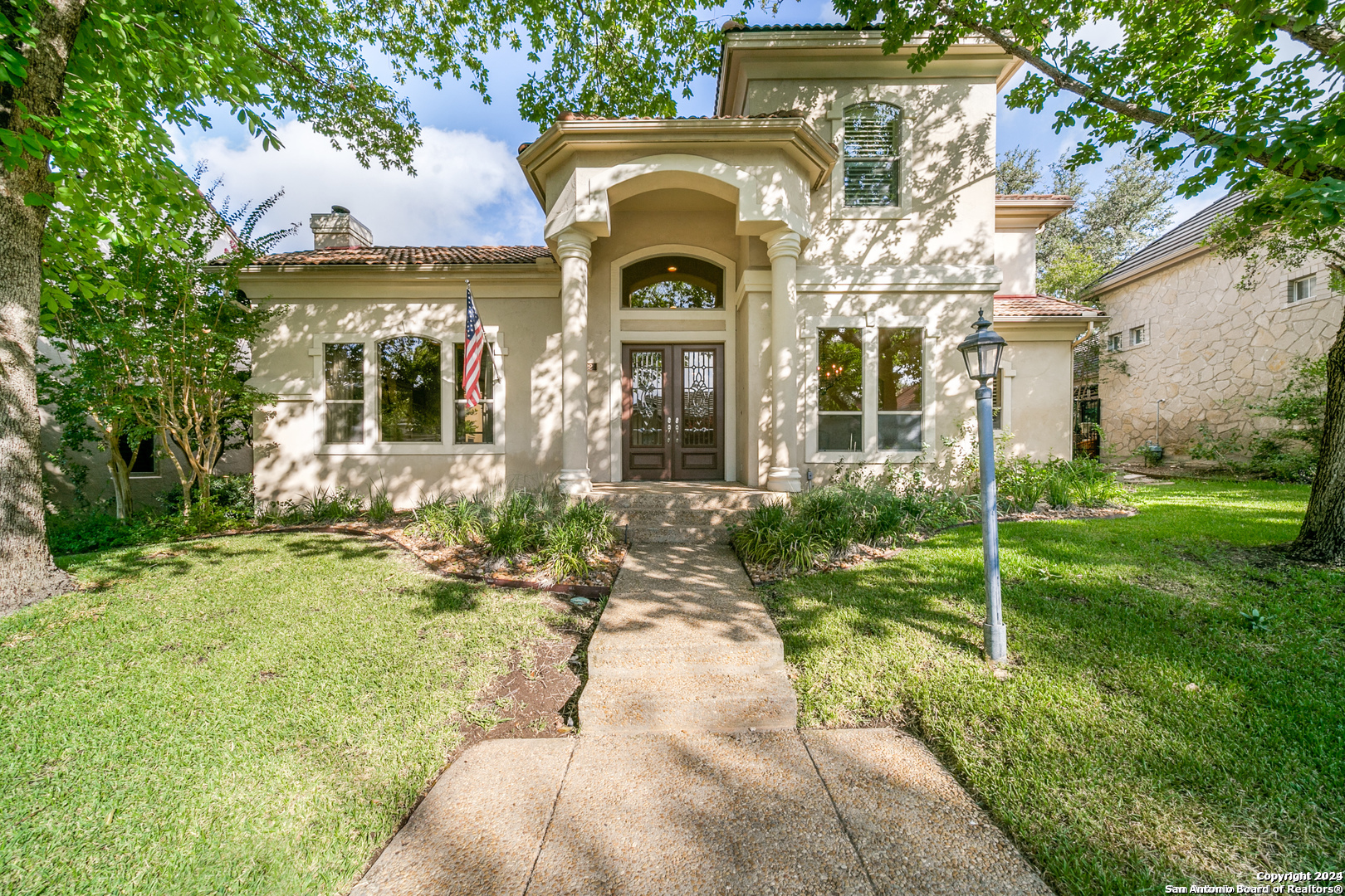 a front view of a house with garden