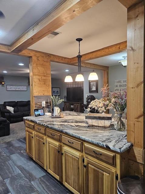 a large kitchen with kitchen island a counter space a sink and stainless steel appliances