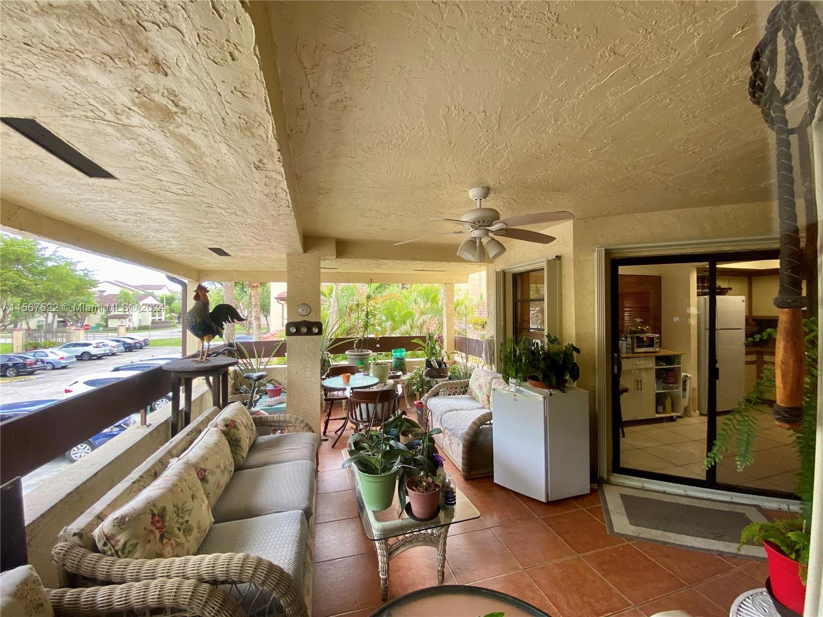 a living room with furniture floor to ceiling window and outdoor view