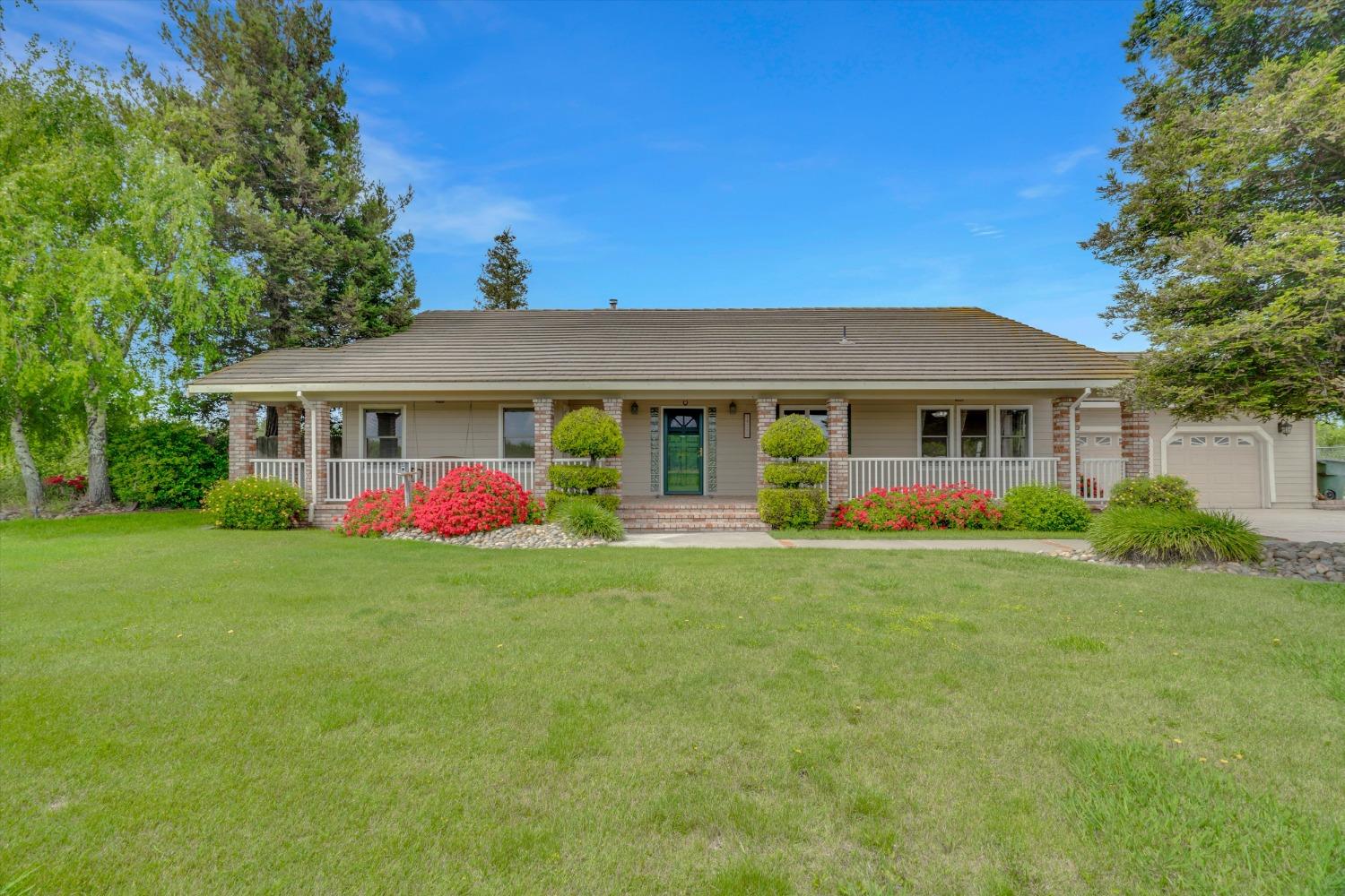 a front view of a house with a big yard