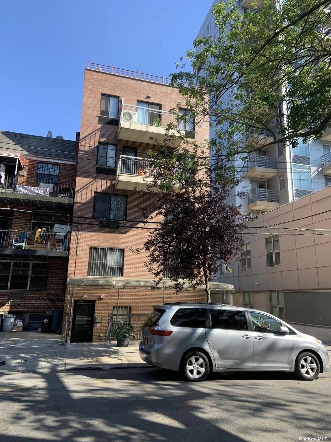 a front view of a house with parking space