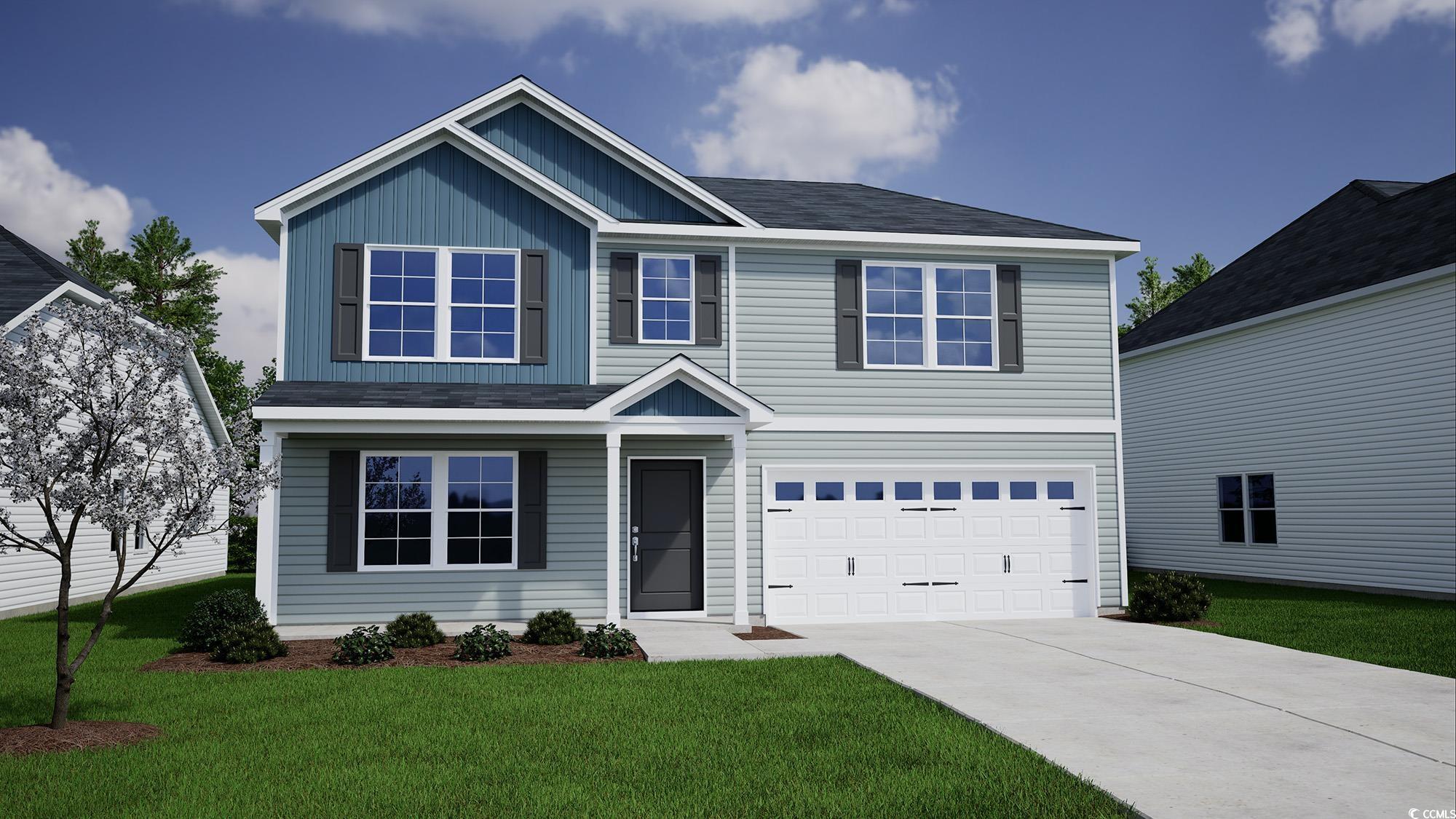 View of front of home with a garage and a front la