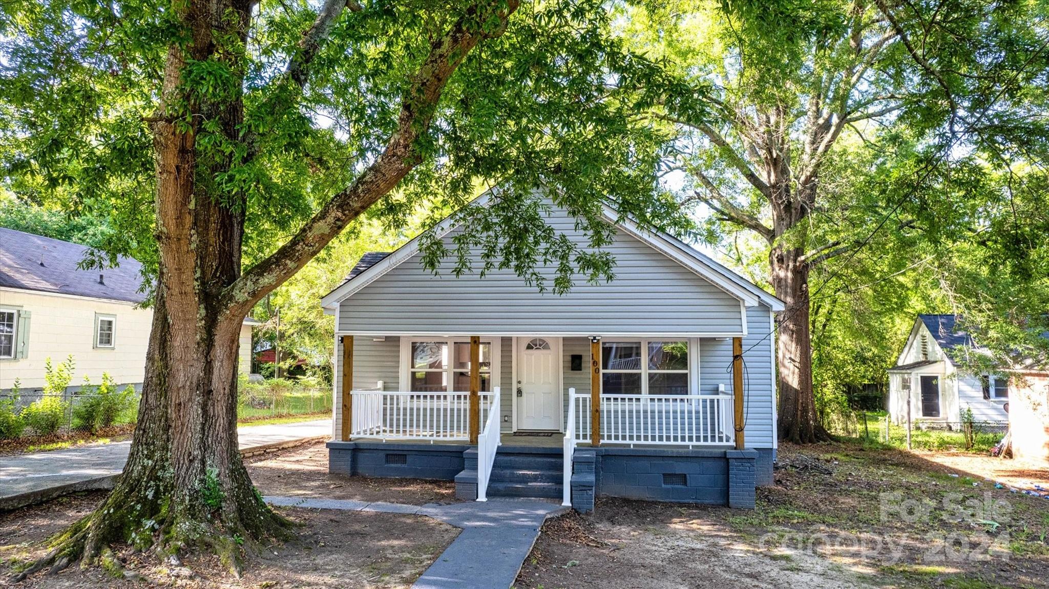 a house that has a tree in front of it