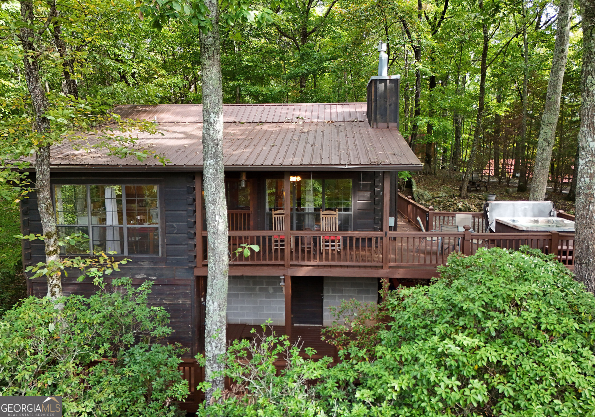 a view of a house with a deck and a garden