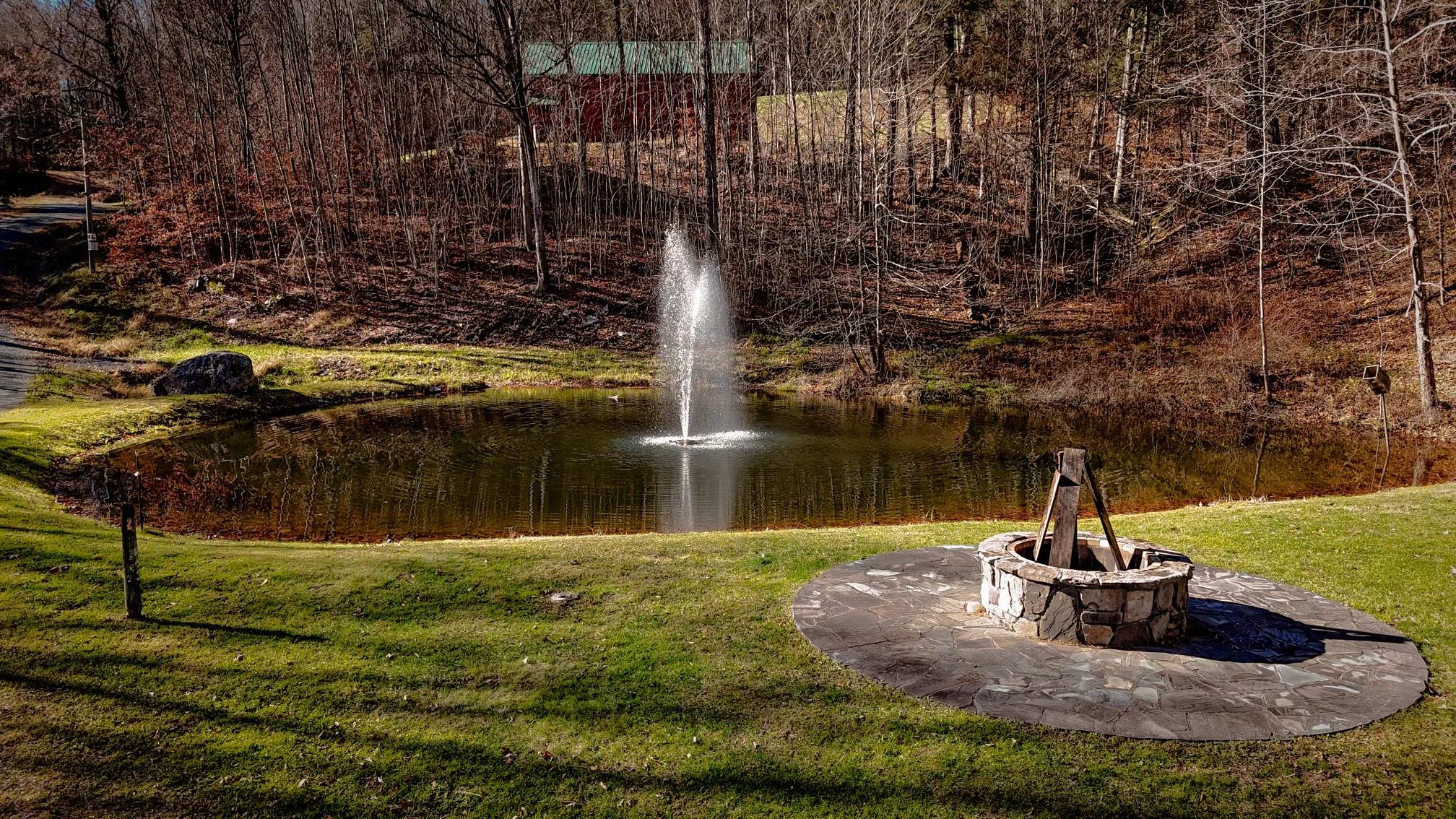 Surrounding community featuring a lawn and a water view