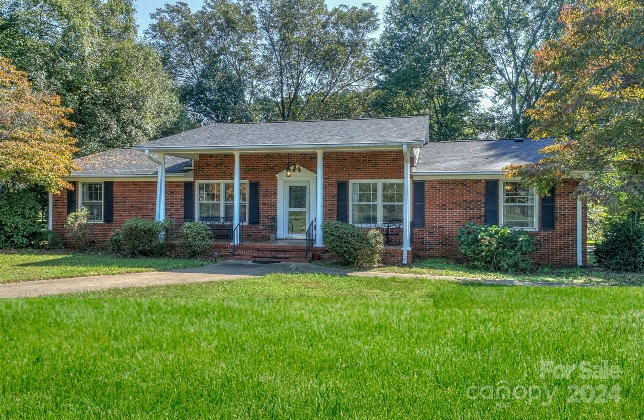 a front view of a house with a yard and porch