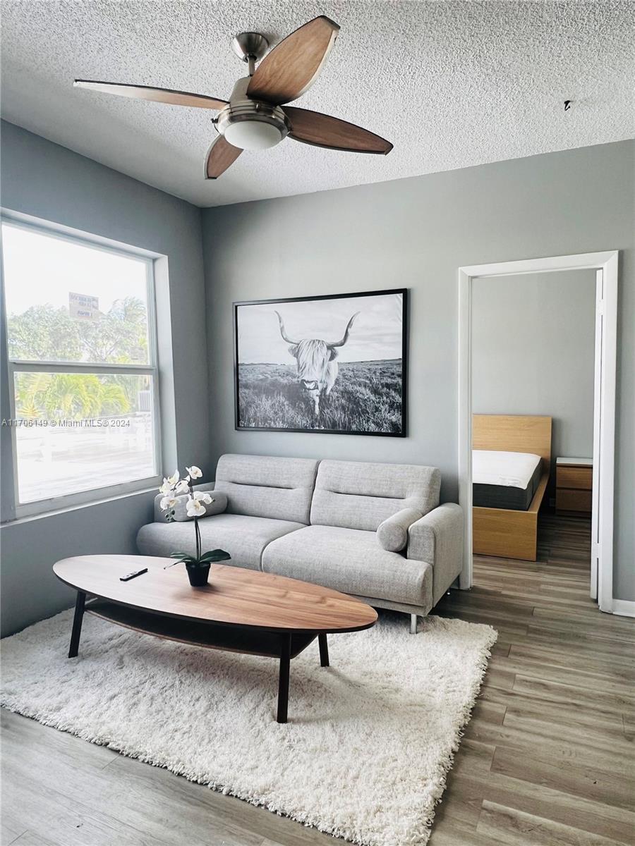 a living room with furniture a rug and a window