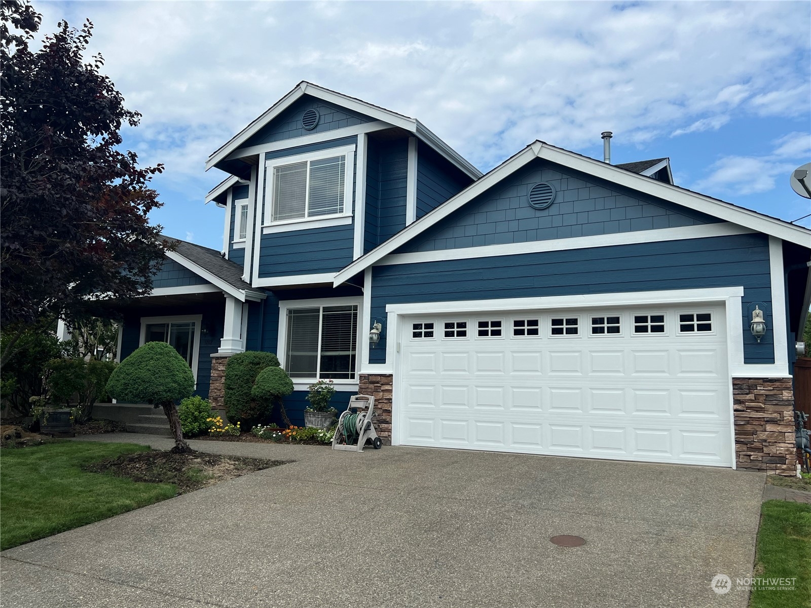 a view of a house with a yard and garage