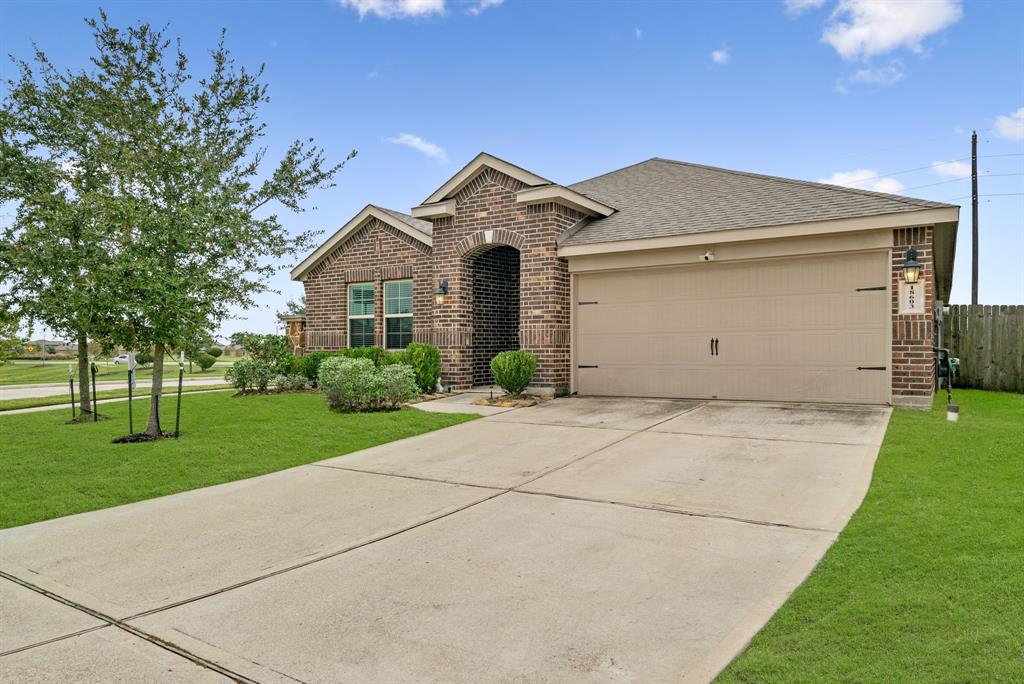 a view of a house with a yard and garage