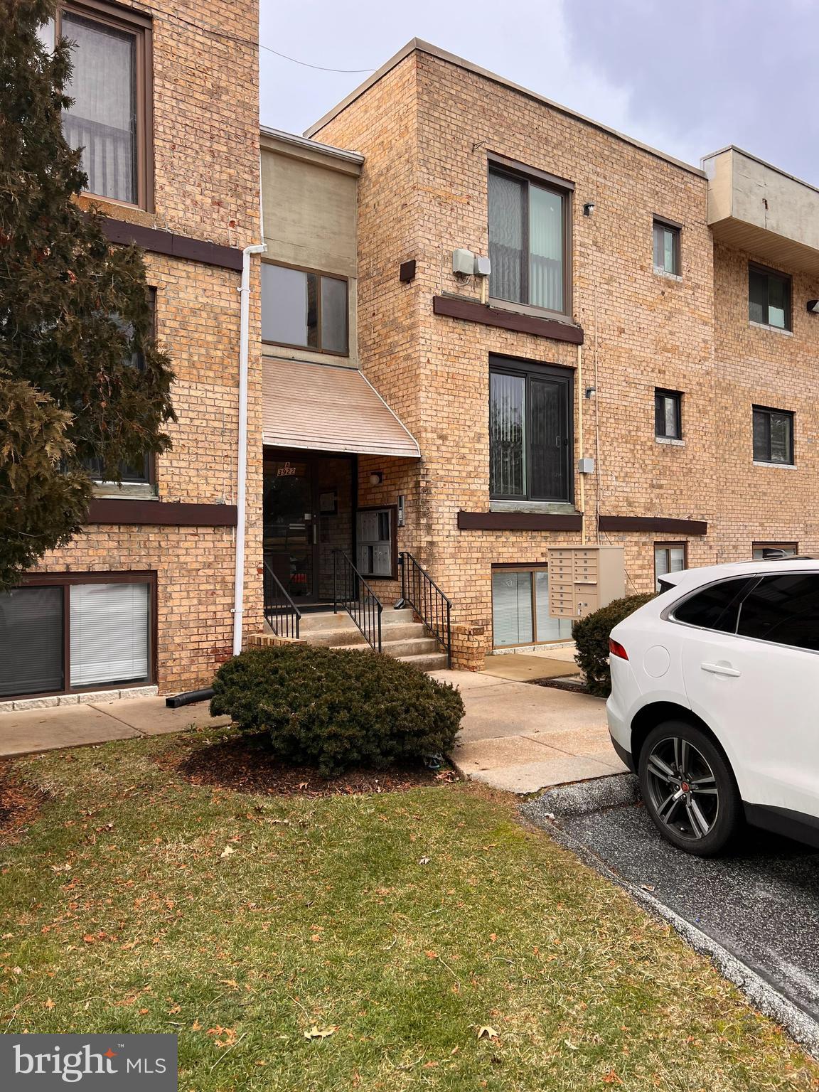 a car parked in front of a brick house