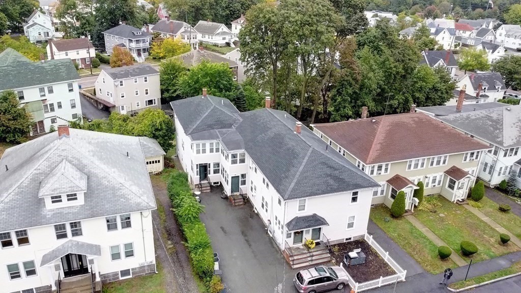 an aerial view of multiple houses with yard