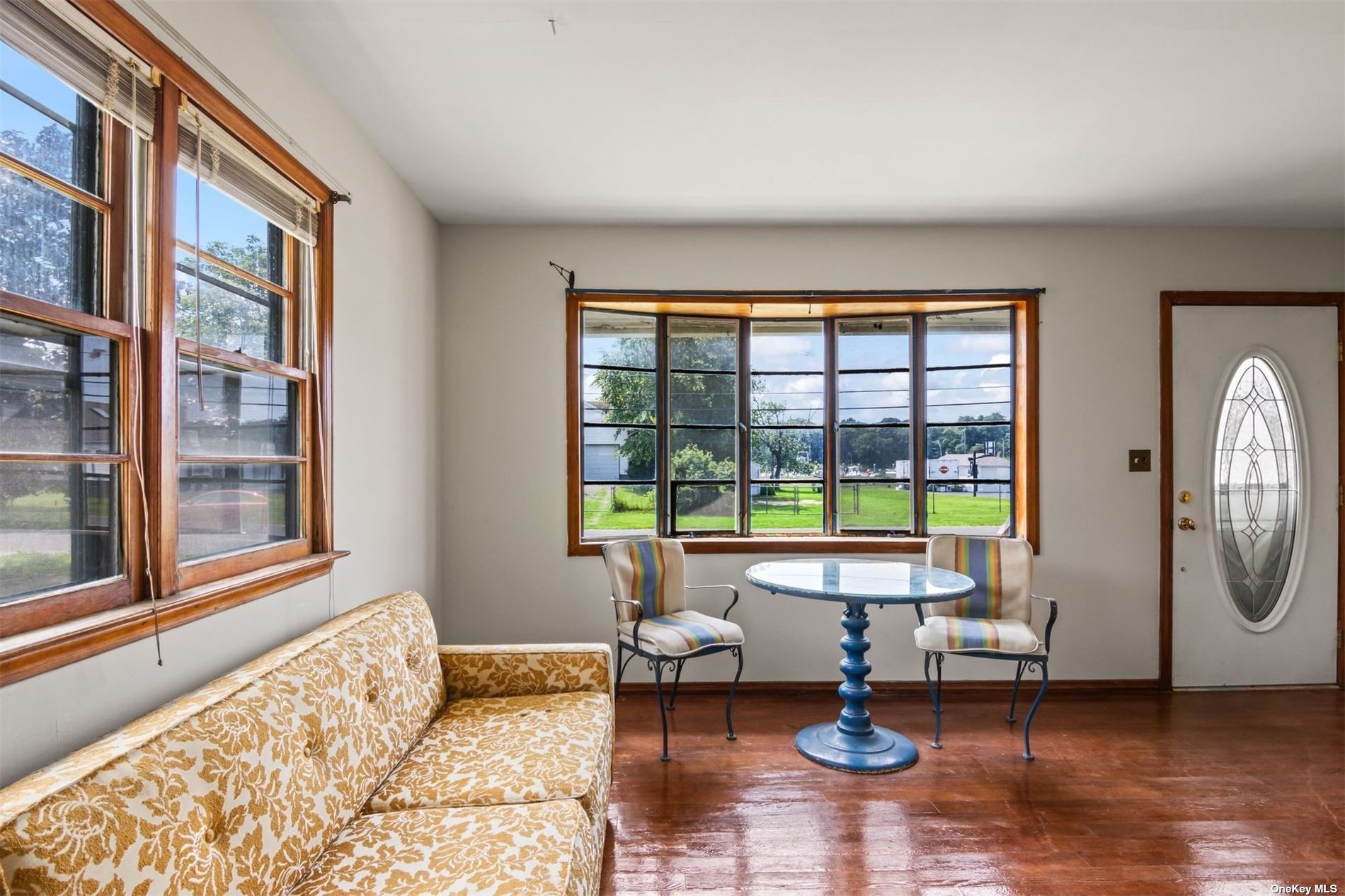 a living room with furniture and a floor to ceiling window